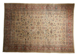 Distressed vintage Tabriz carpet with scrolling leaves on a pale gold field and a cherry red border.