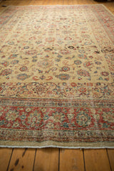 A low angle view highlighting the time-softened low pile of a distressed vintage Tabriz carpet.