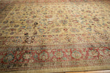 Low-angle view across a distressed Tabriz carpet revealing its textured, time-softened pile and pattern.