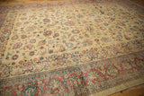 Low angle perspective across the textured, worn pile of a distressed vintage Tabriz carpet.