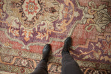 Time-softened texture of a vintage Oushak rug with decorative wear and pops of violet and orange.