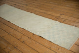 Vintage distressed Oushak runner featuring subtle checkered pattern and pastel highlights.