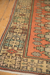 Geometric beige border and terracotta quatrefoil patterns on a distressed vintage Dosemealti rug.