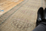Distressed Oushak runner pile texture with mostly even wear, visible foundation, and faded pale violet designs.