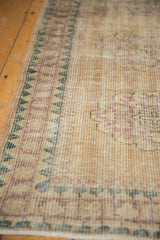 Distressed vintage Oushak runner edge, featuring pale turquoise and violet stepped borders.