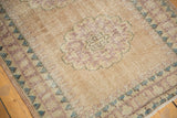 Distressed vintage Oushak rug detail: pale violet, turquoise patterns, and visible foundation.