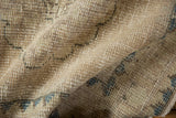 Textured pile of distressed Oushak runner, showing mostly even wear and pale blue patterns.