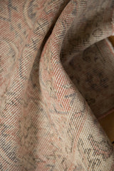 Distressed texture and visible foundation of the Sparta rug in pale rose and ivory.