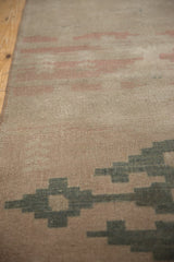 Distressed Oushak runner, showing faded blush, dusty charcoal geometric patterns, and even wear.