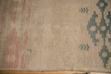 Vintage distressed Oushak rug runner with antique ivory, blush, and dusty teal geometric details.