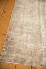 Vintage distressed Oushak runner corner showing worn texture and pale mauve hues.