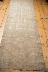 Full length distressed Oushak rug runner, featuring faded mauve, seafoam, and ivory hues.