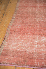 Distressed Oushak rug runner with faded raspberry abrashes, striations, and subtle foundation visibility.