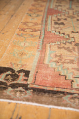 Angled perspective of a distressed Oushak runner, detailing its low pile and serrated medallions.