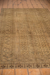 Close-up of distressed Turkmen rug with rams horn border, geometric designs, beige gold.
