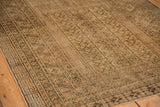 Corner detail of the vintage Turkmen rug's rams horn border, with time-softened tones.