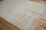 Distressed Oushak carpet with even wear to knot heads, revealing faint ivory and blush patterns.