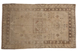 Distressed Uzbeki Khotan rug: antique ivory, charcoal, dusty rose floral medallion, 4'6