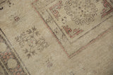 Vintage distressed Khotan rug shows mostly even wear, revealing the beige foundation.