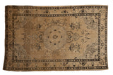 Distressed vintage Sivas rug, central roundel medallion, scrolling botanical patterns in soft beige, charcoal.