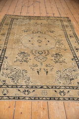 Distressed Sivas rug with visible foundation, even wear, and faded roundel medallion on beige.