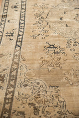 Distressed beige pile texture with charcoal vinery on a vintage Sivas rug.