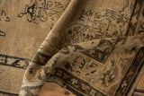 Worn texture and muted colors on a folded vintage distressed Sivas rug.