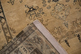 Distressed vintage Sivas rug's folded corner, revealing worn beige pile, dark motifs, and knotted foundation.