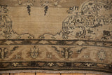 Distressed Sivas rug border detail with beige and charcoal geometric motifs, soft wear, and fringe.