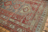 Distressed cherry red and pale blue geometric border with saffron accents and selvage.