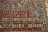 Distressed geometric patterns on a vintage Caucasian carpet border, cherry red and denim blue.
