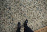 Distressed Sivas carpet, dusty teal and ivory lattice, four seasons motif, cartouche border.