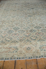 Distressed Sivas carpet detail: ivory, dusty teal four seasons motif and cartouche border.
