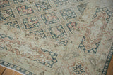 Distressed Sivas rug with dusty teal diamond seasonal motifs and cartouche border detail.