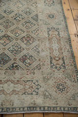 Vintage Sivas rug: Distressed ivory, teal cartouche border and faded diamond field.