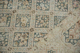Distressed Sivas carpet corner, revealing botanical lattice and cartouche border in ivory and teal.