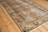 Vintage Distressed Malayer rug featuring worn floral patterns and palmette border in muted tones.