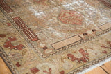 Distressed Malayer rug corner with terra cotta palmettes and time-softened floral patterns.