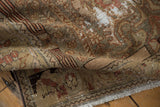 Curled Malayer rug highlights distressed pile, foundation showing, muted floral patterns, and fringe.