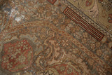 Distressed vintage Malayer rug detail, worn floral patterns in chestnut, olive, and terra cotta.