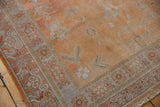 Khotan carpet corner with nuanced geometric borders and distressed burnt orange field.