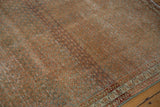 Faded terra cotta Mir boteh field of a distressed Serbend rug with geometric border.