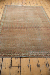 Distressed Serbend rug end with secured fringe, geometric borders, and mostly even wear.