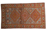 Distressed vintage Caucasian rug, brick red medallions, slate blue ground, 4x6.5.