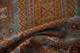 Distressed texture of vintage Caucasian rug, with slate blue, cherry red, gold geometric motifs.
