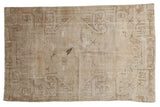 Distressed Khotan rug with faded ivory, charcoal, and blush floral and plant motifs. 4'3