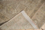 Distressed pile of the vintage Oushak runner showcasing its hand-knotted foundation and side selvage.