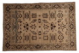 Vintage distressed Malayer rug with a large-scale geometric pattern in neutral shades of sand, beige, and dark brown.