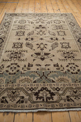 A low perspective on a distressed Malayer rug showing its even wear and interconnected starburst designs.