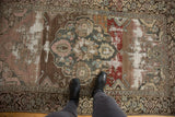 Distressed vintage Malayer rug with varied brick red, mauve, charcoal tones, and foundation wear.